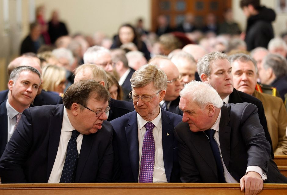 Former taoisigh, Brian Cowen, left and Bertie Ahern, right, with former Fianna Fáil politician Donie Cassidy (middle) at the state funeral of John Bruton at St Peter and Paul's Church, in Dunboyne. Photo: Julien Behal/ via Reuters