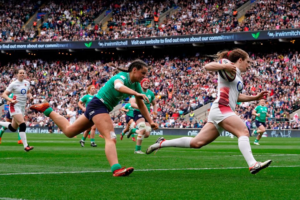 England's Abby Dow (right) passes Ireland's Katie Corrigan as she runs in to score a try. Photo credit: Gareth Fuller/PA Wire.