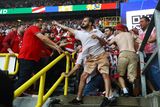 thumbnail: A Georgia fan takes a swing at the Turkey side in Dortmund. Photo: Reuters/Wolfgang Rattay