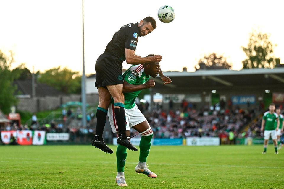 Tunde Owolabi of Cork City is tackled by Roberto Lopes of Shamrock Rovers during the game. Photo: Eóin Noonan/Sportsfile