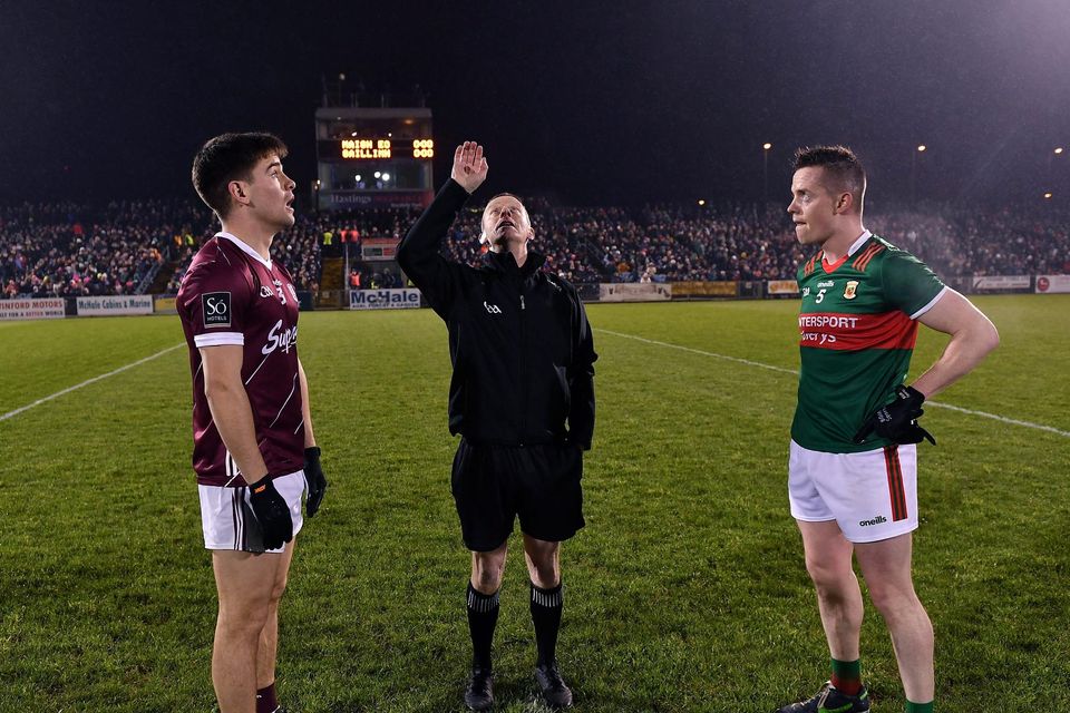 Referee Joe McQuillan alongside Galway's Seán Kelly and Mayo's Stephen Coen before the Division 1 match at MacHale Park in Castlebar. Photo: Sportsfile