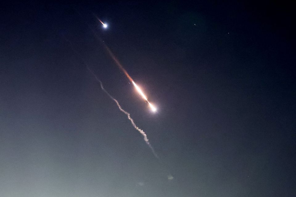 Objects are seen in the sky above Jerusalem after Iran launched drones and missiles towards Israel (REUTERS/Ronen Zvulun)