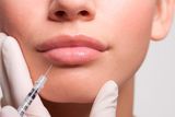 thumbnail: Close up of woman receiving Botox injection in lips. Stock picture