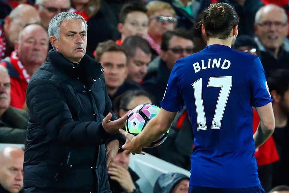 Jose Mourinho hands the ball to Daley Blind during Manchester United visit to Anfield last season, which finished scoreless. Photo: Getty