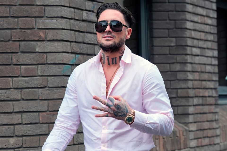 Stephen Bear, makes a gesture as he leaves Chelmsford Crown Court, Essex, after his confiscation hearing