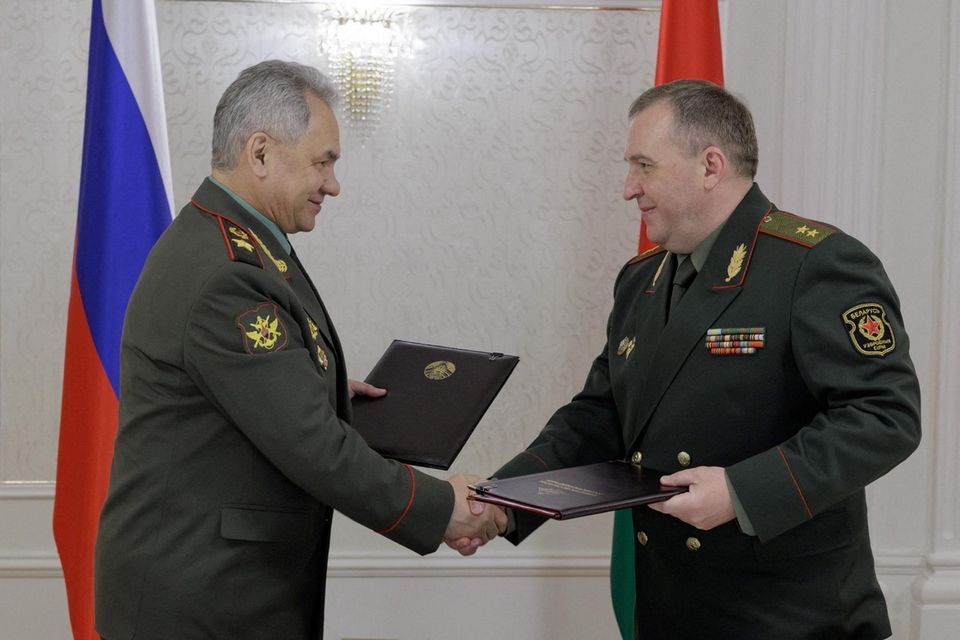 Russian defence minister Sergei Shoigu shakes hands with Belarusian defence minister Victor Khrenin in Minsk yesterday. Photo: Russian Defence Ministry via Reuters