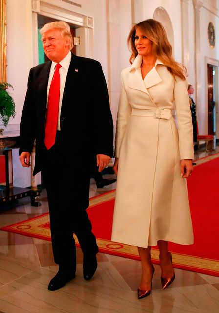 U.S. President Donald Trump and first lady Melania Trump walk into the East Room to attend an event celebrating Women's History Month, at the White House March 29, 2017 in Washington, DC.  (Photo by Mark Wilson/Getty Images)