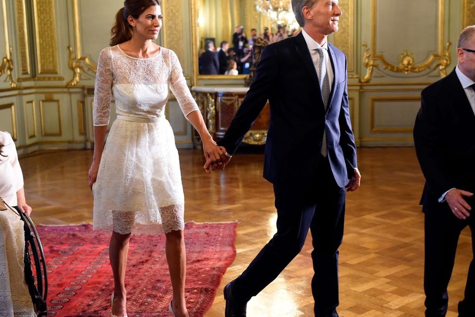 Argentina's new President Mauricio Macri (C) leaves the Foreign Ministry building with his wife, First Lady Juliana Awada, in Buenos Aires on December 10, 2015