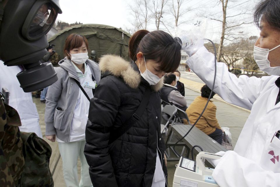 Warning signs: A hospital worker from Fukushima is checked for radioactivity shortly after the power plant was wrecked by the 2011 earthquake and tsunami