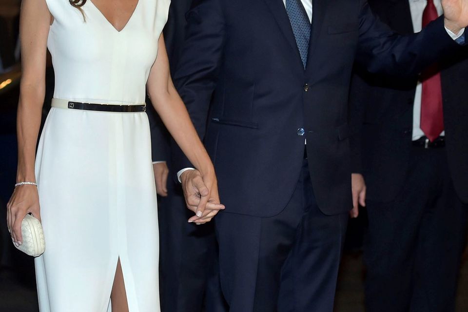 Handout photo released by Noticias Argentinas of Argentina's President-elect Mauricio Macri (R) waving as he arrives to the Colon Theater with First Lady Juliana Awada for a gala in Buenos Aires on December 10, 2015.