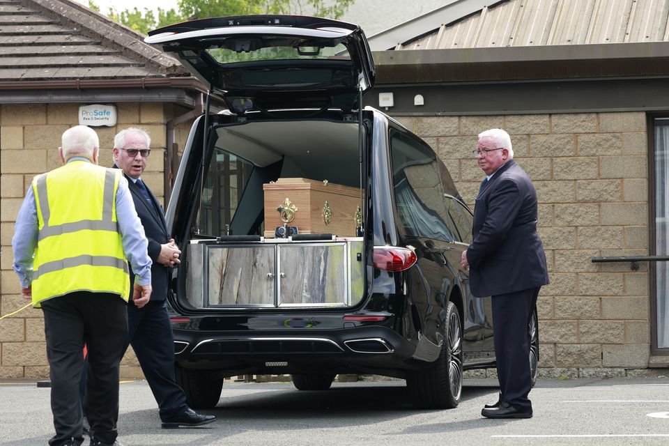 The coffin of Bishop Brendan Comiskey arrives at the Church of the Sacred Heart, in Clondalkin (Arthur Carron/PA)