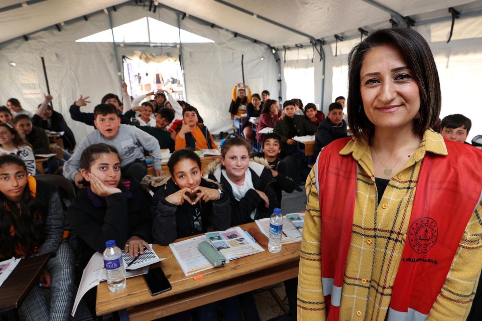 Huda Tarsuslu Toluca , an English and Arabic Teacher at a Unicef supported learning space with her class at Orhanli Camp in Hatay following February's deadly earthquake in Turkey.