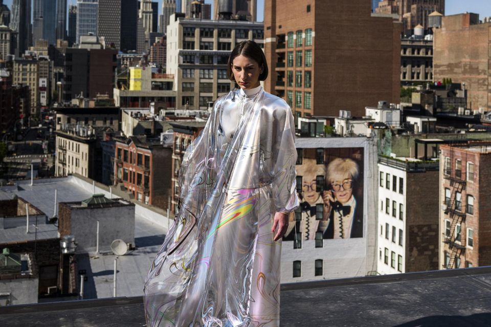 futuristic concept rendering showing augmented reality fashion experience with digital blind box collectibles floating around physical clothing
