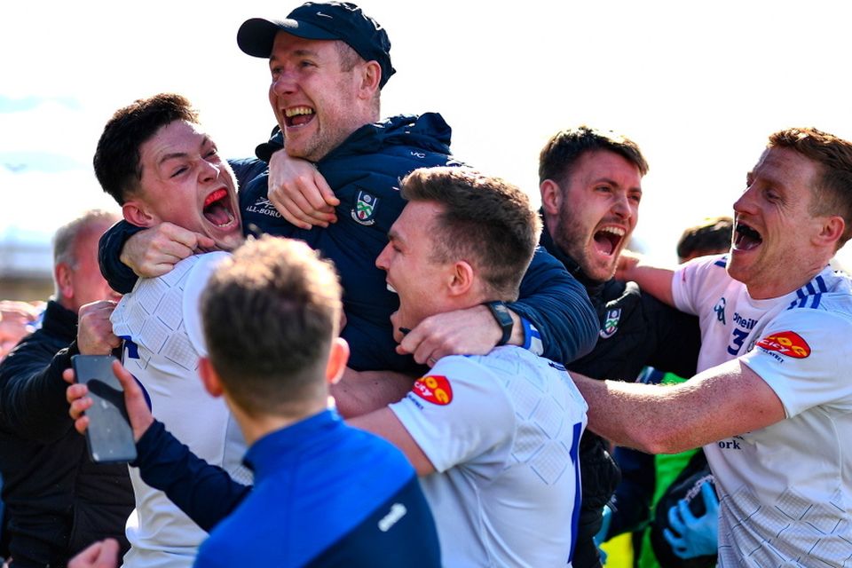 Monaghan players celebrate with their manager Vinny Corey, top