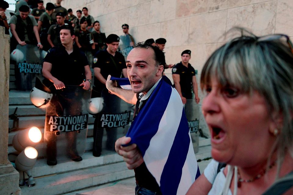People demonstrate in front of the stairs leading to the Greek parliament in Athens during an anti-EU demonstration in Athens calling for a 'NO' to any agreement with the creditors on July 13, 2015. Eurozone leaders struck a deal Monday on a bailout to prevent debt-stricken Greece from crashing out of the euro, forcing Athens to push through draconian reforms in a matter of days. AFP PHOTO / ANDREAS SOLAROLOUISA GOULIAMAKI/AFP/Getty Images