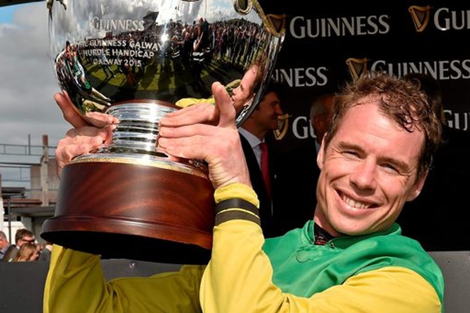 30 July 2015; Denis O'Regan lifts the trophy after winning winning the Guinness Galway Hurdle Handicap on Quick Jack. Galway Racing Festival, Ballybrit, Galway. Picture credit: Cody Glenn / SPORTSFILE