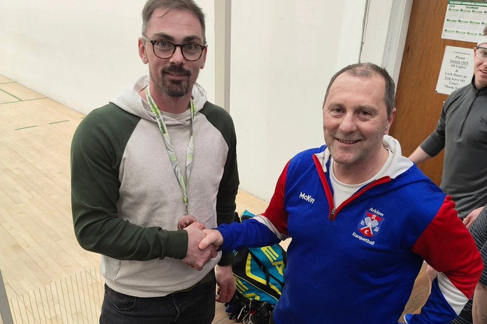 Arklow's Scott Young receiving his silver medal from the men's open doubles competition from tournament director Jimmy Gannon of Arklow Racquetball Club.  