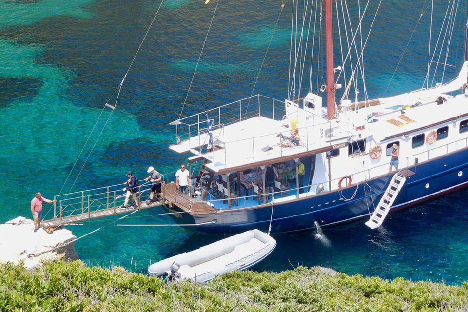 Guests disembarking a sailing boat at Kyra Panagia island. PA Photo/Fiona Webster.