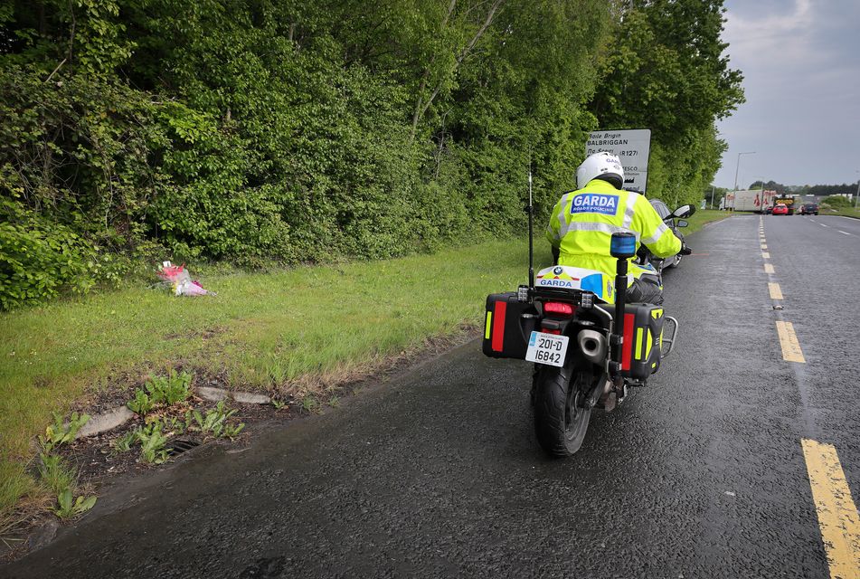 A Roads Policing Unit Garda motorcycle officer stops to pay his respects near where Garda Kevin Flatley was killed as he tried to flag down a motorcyclist while operating a traffic checkpoint at Lanestown near Swords. Picture:Frank McGrath