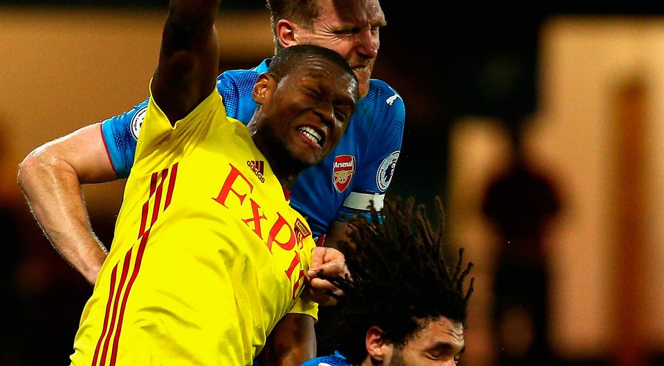 Christian Kabasele of Watford jumps between Per Mertesacker and Mohamed Elneny of Arsenal. Photo: Getty Images
