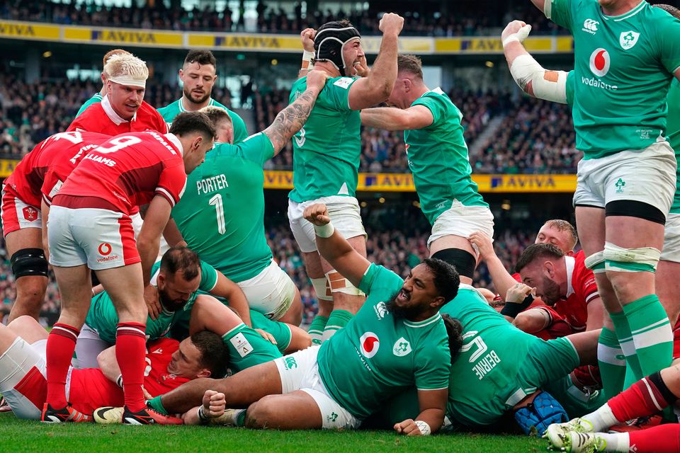 Ireland's Bundee Aki (bottom) and team-mates celebrate after Dan Sheehan (hidden) scores their side's first try during the Six Nations clash with Wales at the Aviva Stadium
