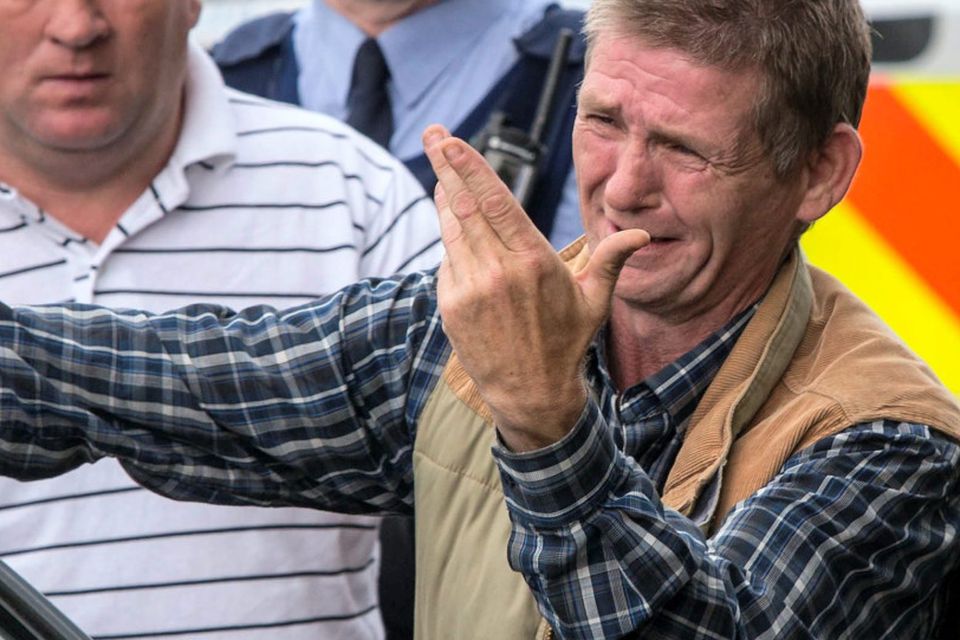 GRIEF-STRICKEN: Thomas O'Driscoll is distraught as his sons' remains are brought out. Photo: Mark Condren