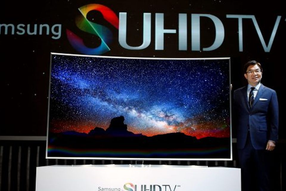 Kim Hyun-seok, head of Samsung Electronics' television division, poses for photographs with a Samsung Electronics S'UHD smart TV during its launch event