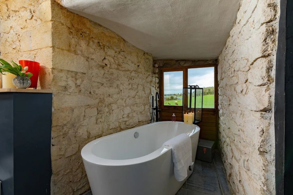 En-suite bathroom with bath overlooking the surrounding countryside. Photo: Airbnb