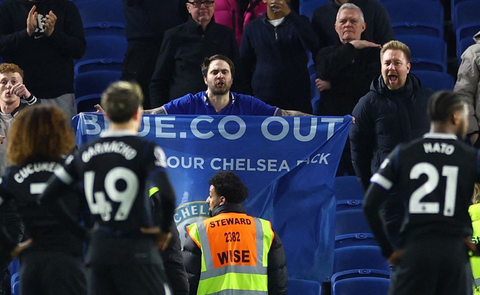 Chelsea fans react a players stand dejected after their defeat to Brighton