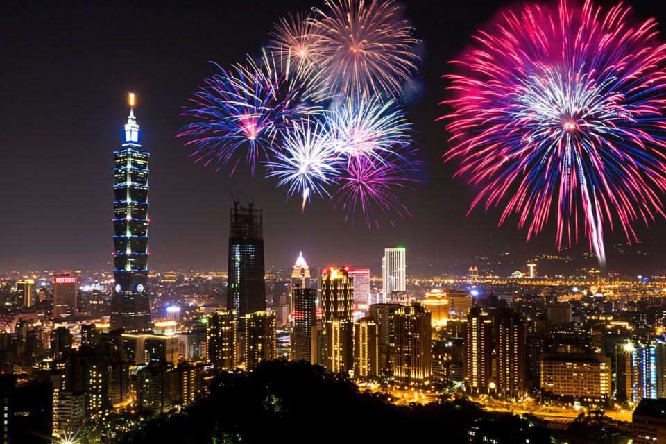 The capital of Taiwan in festive mood, with Taipei 101 standing tall over the city as the good luck rockets crackle