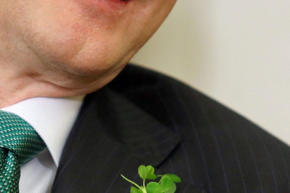 Ireland's Prime Minister Enda Kenny wears a shamrocks on his lapel as he meets U.S. President Barack Obama in the Oval Office during a St. Patrick's Day visit to the White House in Washington March 17, 2015. REUTERS/Jonathan Ernst