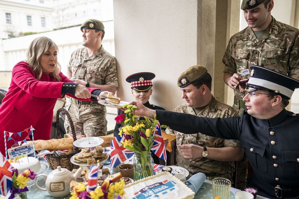 Presenter Mel Geidroyc with members of the Scots Guards and Coldstream Guards during the Coronation Big Lunch with military at Wellington Barracks, London (Aaron Chown/PA)