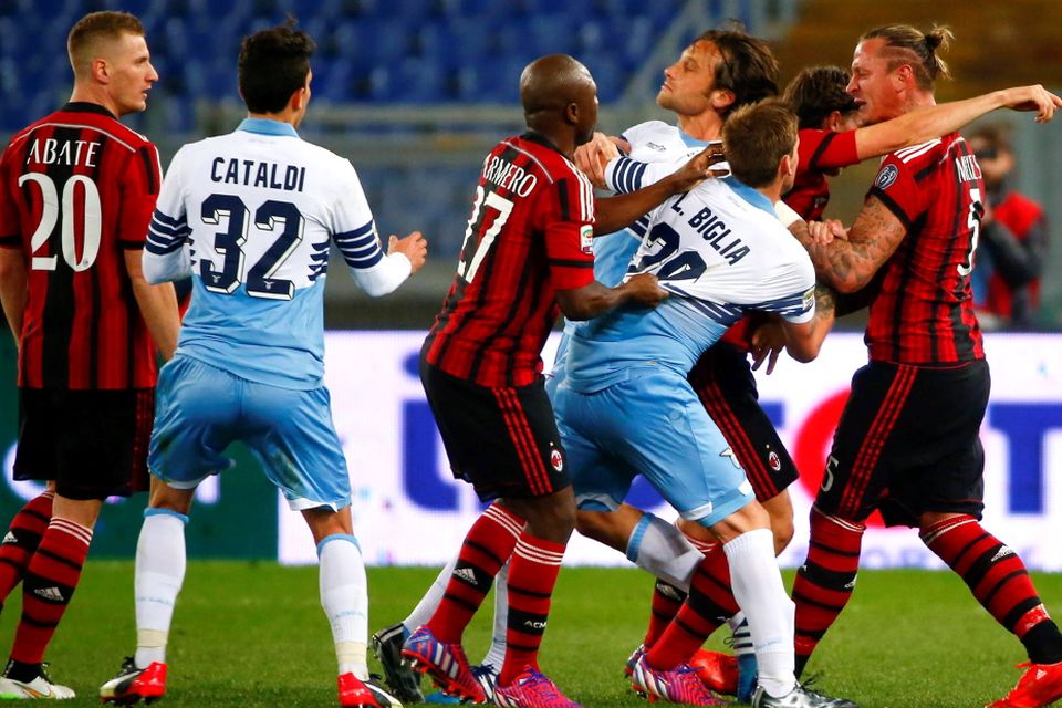 AC Milan's Philippe Mexes (R) reacts with Lazio Stefano Mauri (3rd R) during their Italian Serie A soccer match at the Olympic stadium in Rome January 24, 2015