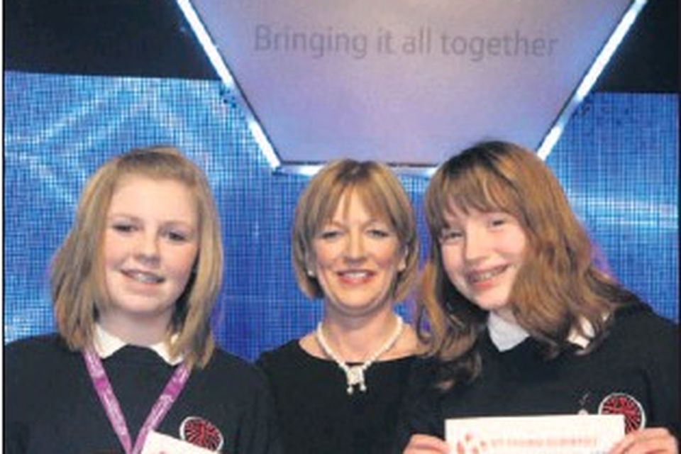 Maureen Walkingshaw, HR director, BT Ireland, who presented the category award chemical, physical and mathematical sciences third junior group category to Grainne Jones and Orla Mannion, from Skerries Community College, for their project 'Can we use...