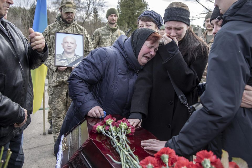 The mother and relatives of serviceman Anatoliy Yalovskyi mourn in Kyiv on Monday. Photo: Narciso Contreras