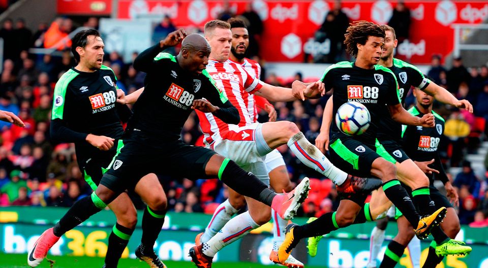 Ryan Shawcross of Stoke City gets between Benik Afobe and Nathan Ake of AFC Bournemouth   Photo: Getty