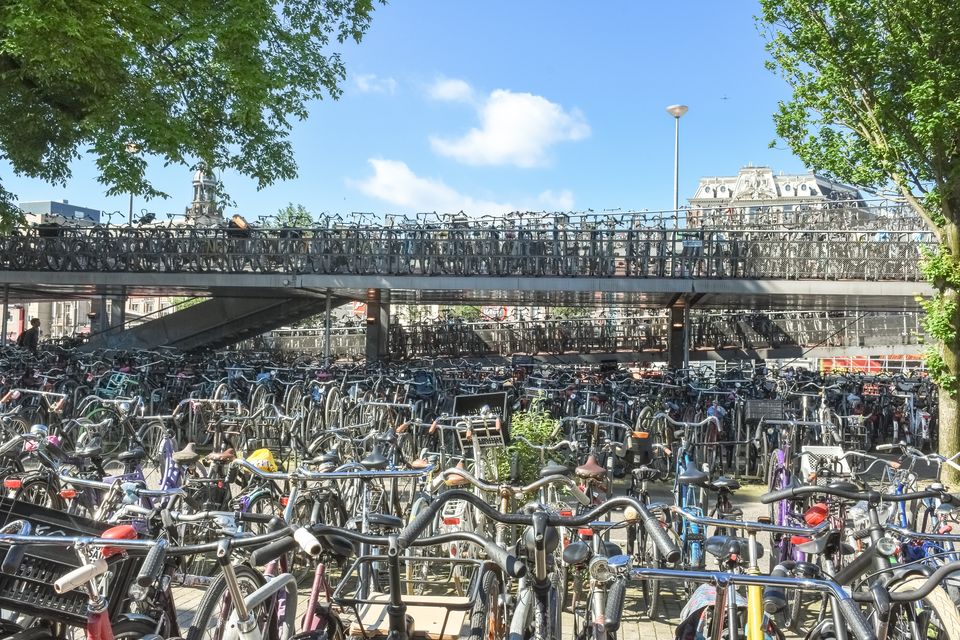 Cycles of all types parked in a public bicycle parking area in Amsterdam, Netherlands