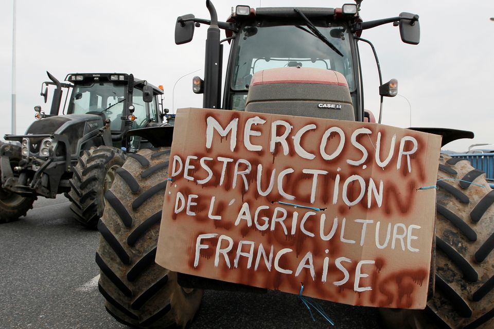French farmers drive their tractors on the A7 highway to protest changes in underprivileged farm area’s mapping and against Mercosur talks, in PIerre-Benite near Lyon, France, February 21, 2018. Message reads, "Mercosur - The destruction of French agriculture".   REUTERS/Emmanuel Foudrot