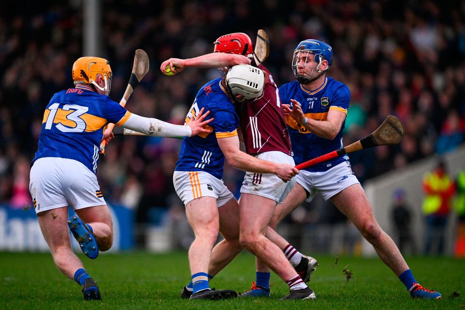 Ronan Glennon of Galway is tackled by Galway players Tom Monaghan, left, Evan Niland and Jason Flynn during the Allianz Hurling League Division 1 Group B match at FBD Semple Stadum in Thurles. Photo: Ray McManus/Sportsfile