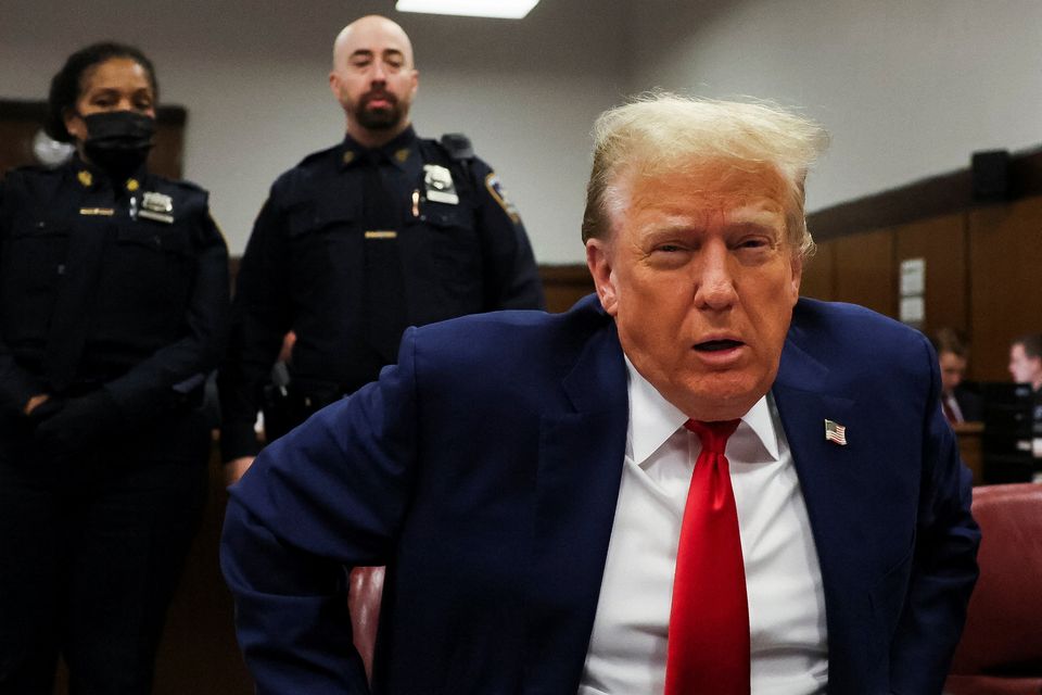 Former US president Donald Trump sits down in the courtroom as he arrives for his criminal trial in New York City. Photo: Reuters