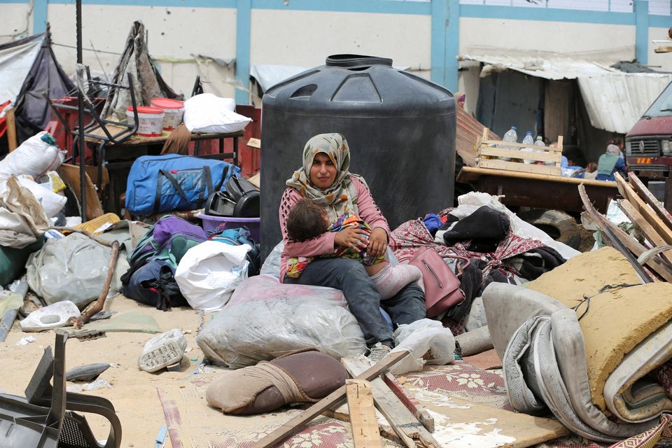 A woman and a child are caught in the middle of the massacre in Rafah, in the south of the Gaza Strip, yesterday.  Photo: Reuters