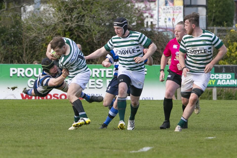 Corinthians John Claffey makes a flying tackle on Greystones' Andrew Lynch.