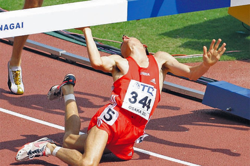 Gunther Weidlinger of Austria falls after crashing face-first into a hurdle during the heats of the men's 3000m steeplechase at the
IAAF World Athletics Championship in yesterday.