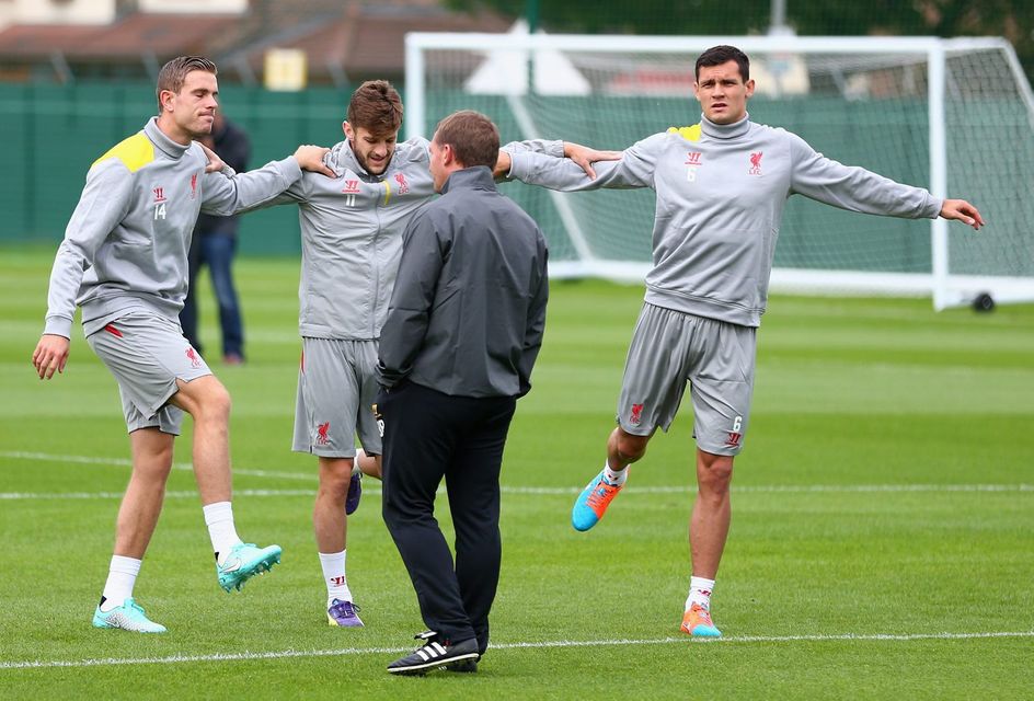 Liverpool manager Brendan Rodgers has a word with L-R Jordan Henderson, Adam Lallana and Dejan Lovren during a training session ahead of their UEFA Champions League group B match against PFC Ludogorets