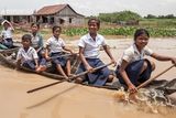 thumbnail: A group of children come back from school riding their boat