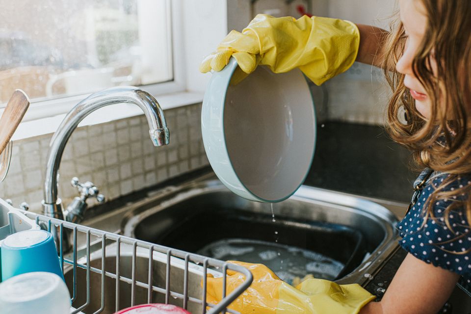 Washing the dishes is one way children earn pocket money. Stock image/Getty