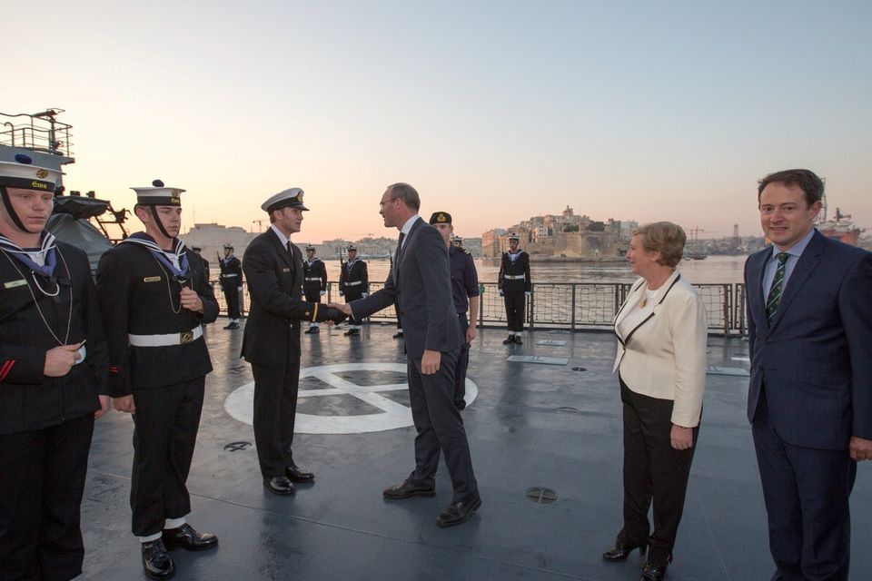 Minister Simon Coveney meeting Ensign Ben Crumplin on the flight deck of the LE Eithne after docking in Valetta, Malta with Mnisters Frances Fitzgerald and Sean Sherlock. Also inlcluded on right is commander Pearse O'Donnell