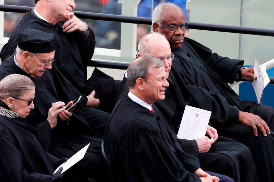 Supreme Court Justices Ruth Bader Ginsburg, (back row front), Stephen Breyer, (back row center), Samuel Alito, (back row, top), Chief Justice John Roberts (C), Anthony Kennedy (front row middle) and Clarence Thomas (front row top) REUTERS/Brian Snyder