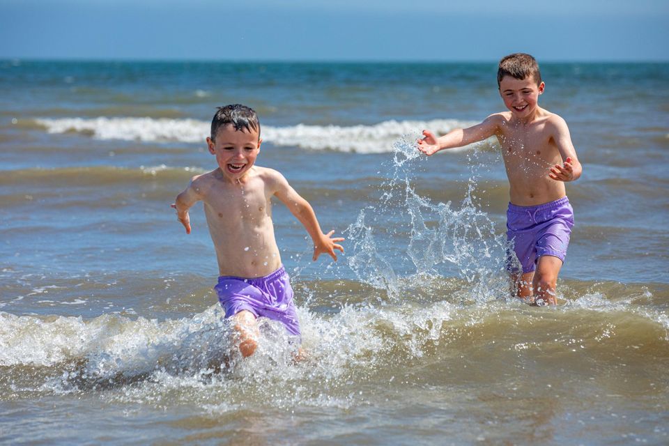 Brothers Cooper and Kalvin Sharlott made the most of the sunny weather yesterday during a trip to Portmarnock Beach, Co Dublin. Photo: Mark Condren