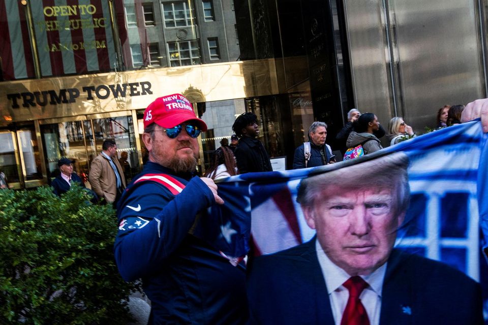 A man holds a fabric with depiction of former US President Donald Trump in front of Trump Tower Photo: Reuters/Eduardo Munoz